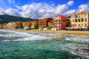 Mediterranean sand beach in traditional touristic town Alassio on italian Riviera by San Remo, Liguria, Italy